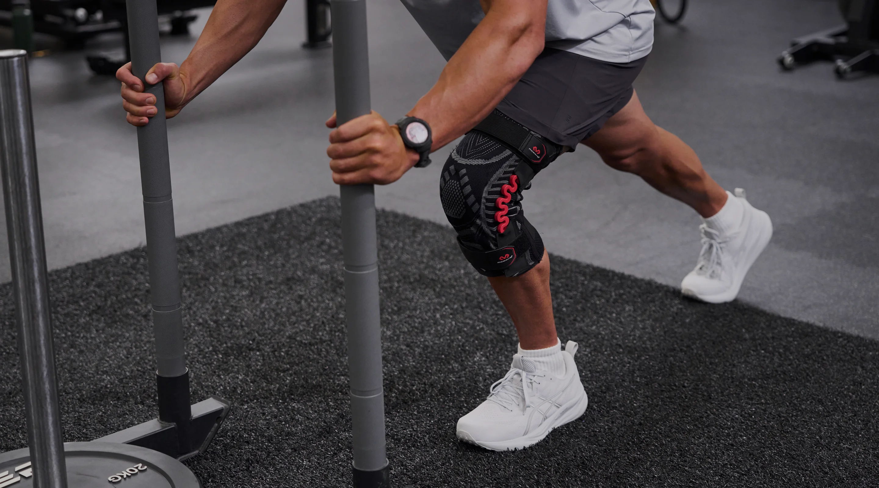 Person exercising with a resistance sled in a gym setting.