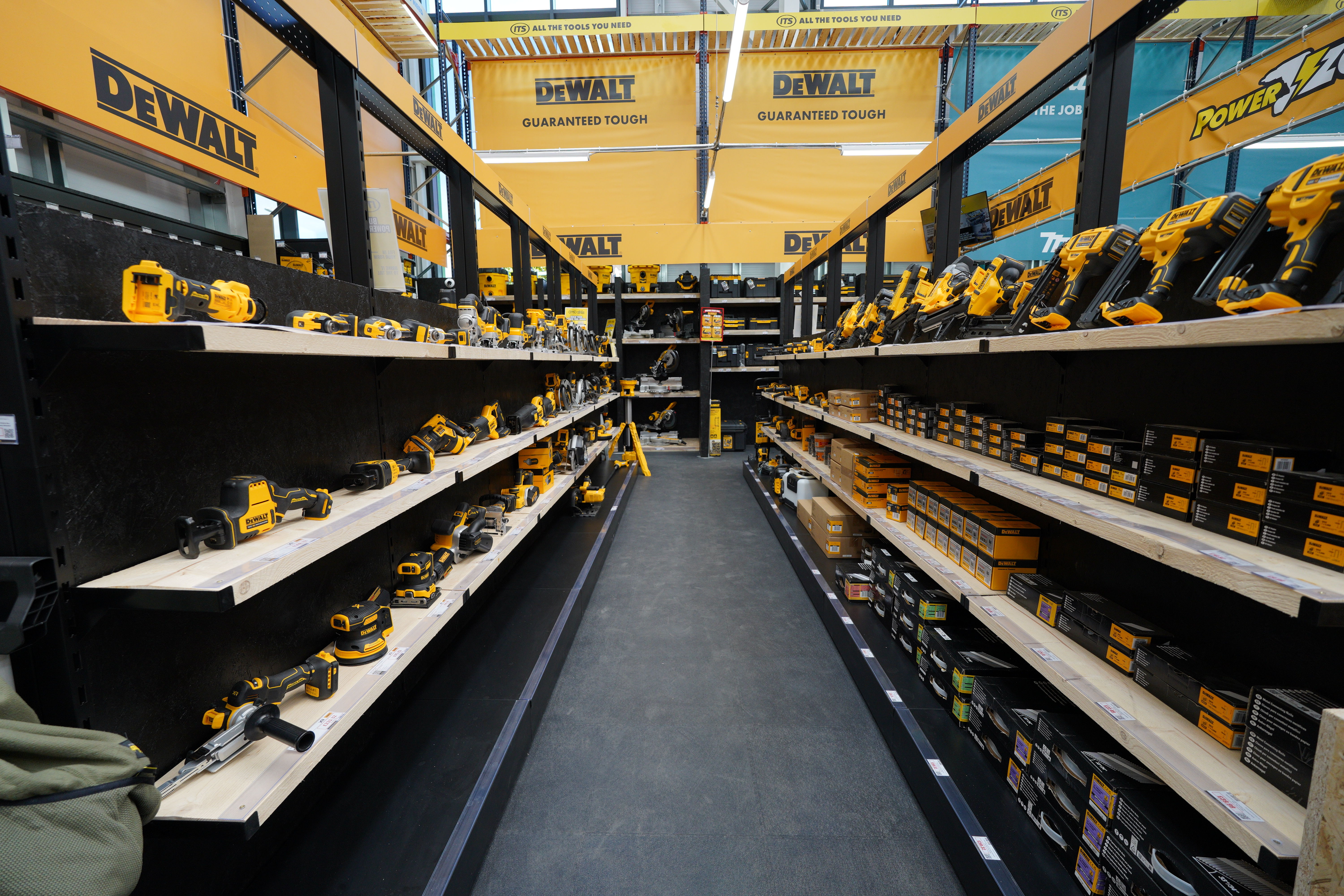 A hardware store aisle filled with power tools and accessories.