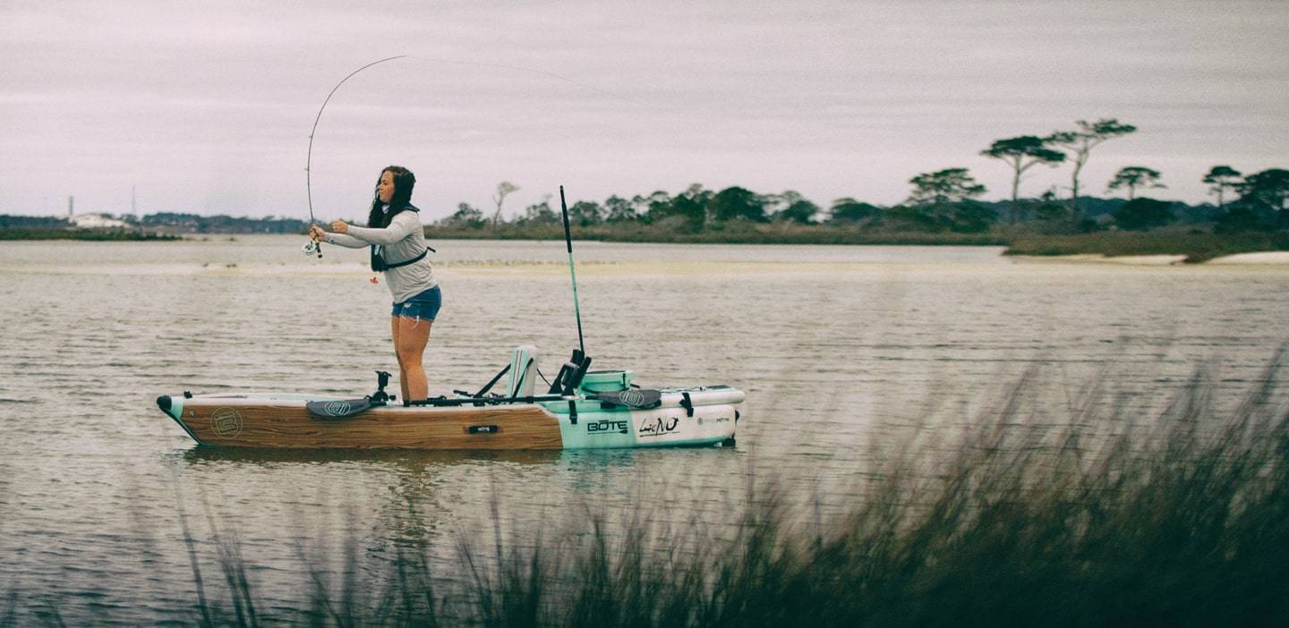Woman fishing from a LONO Aero Classic Teak