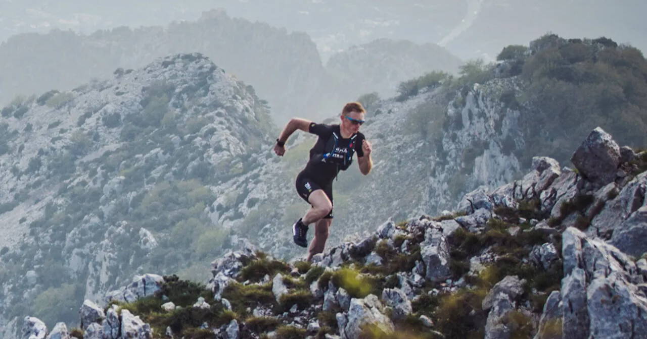 A man running up a mountain with a Garmin fenix 6 on his wrist