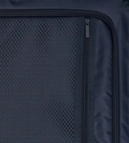 Close-up of a dark fabric with a mesh pocket and zipper.