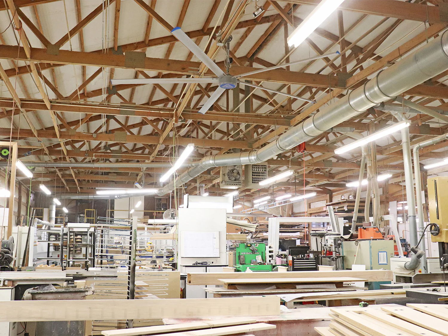 Interior of a workshop with wooden beams and various tools and equipment.