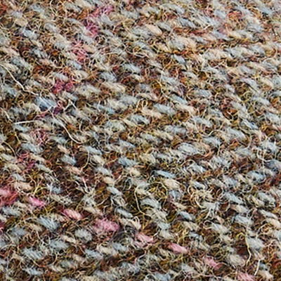 Natural brown, cream and grey Harris Tweed fabric with multicoloured woven texture.