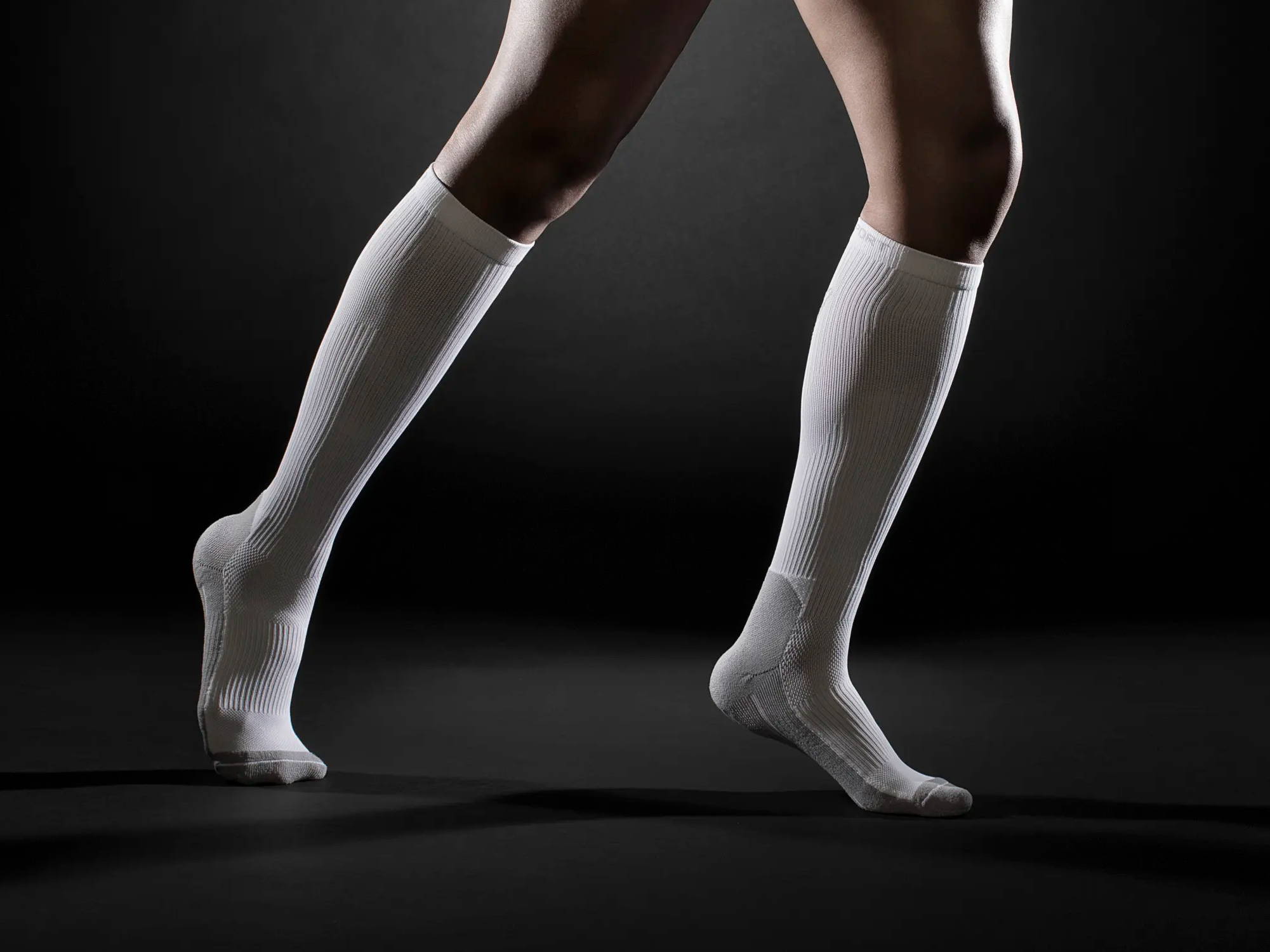 Person standing while wearing TheraSport Athletic Compression Socks