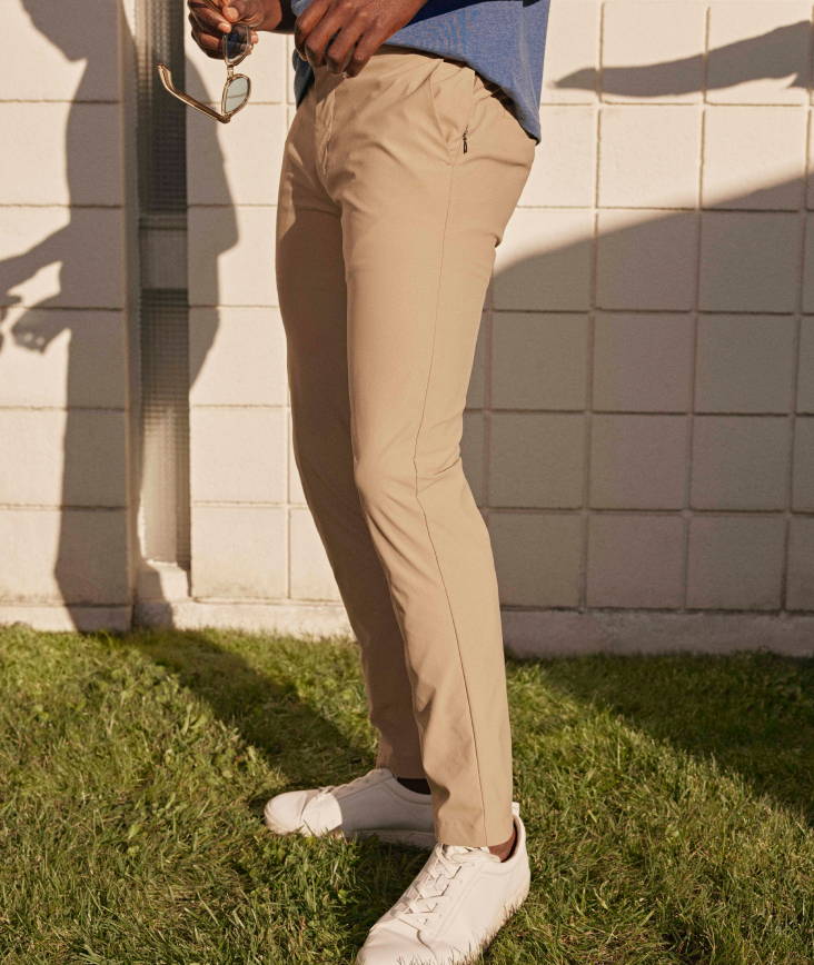 Model is wearing UNTUCKit traveler pants in khaki.