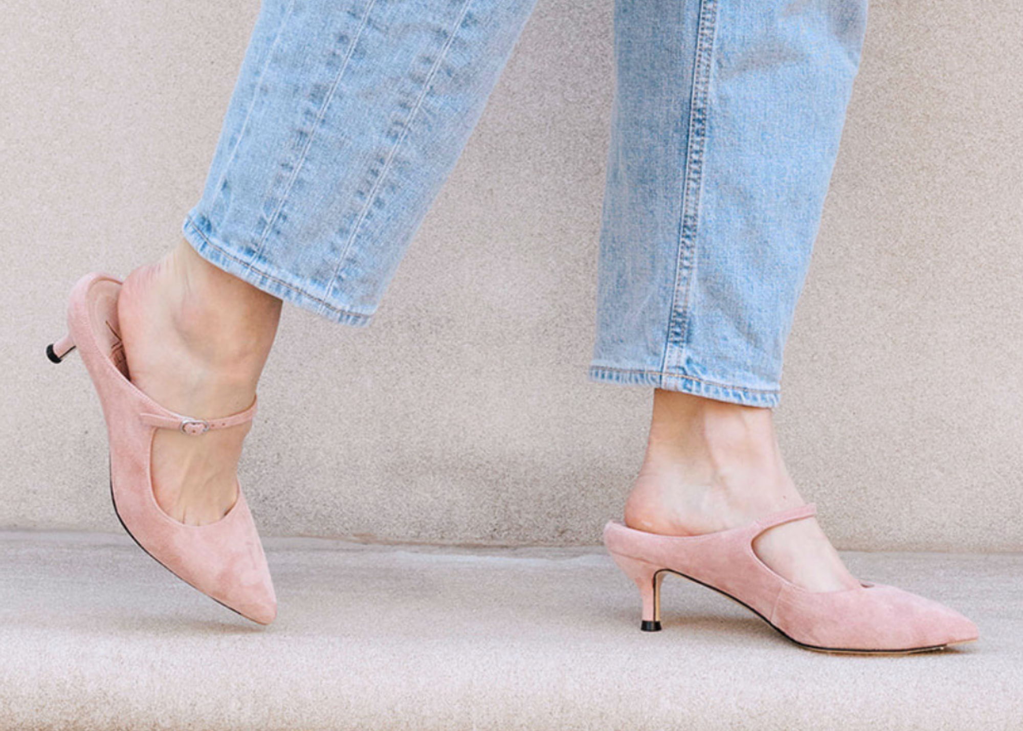 Pink suede high-heeled shoe with a strap and pointed toe.