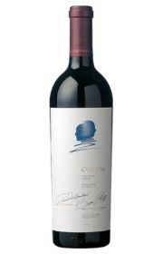 Red wine bottle with a signature and artistic label design.