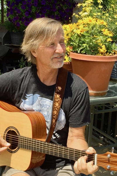 author Dan Chiras playing guitar