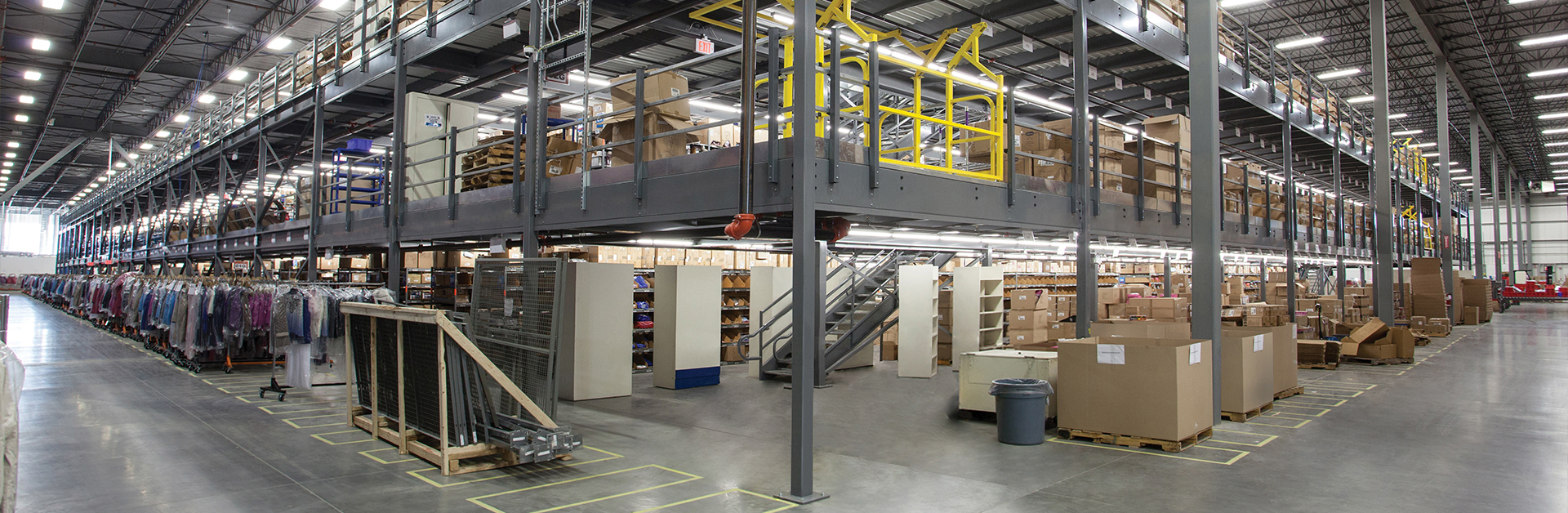 A panoramic view of a warehouse with shelves and stacked boxes.