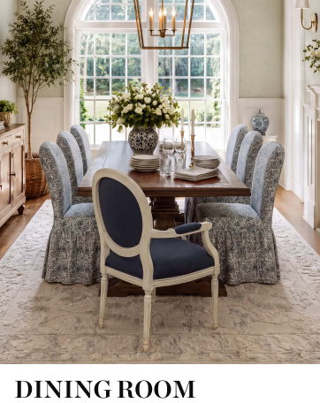 A stylish dining room with a wooden table and upholstered chairs.
