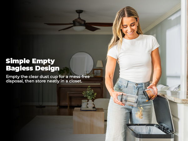Woman emptying a bagless vacuum into a trash bin in a bright room.