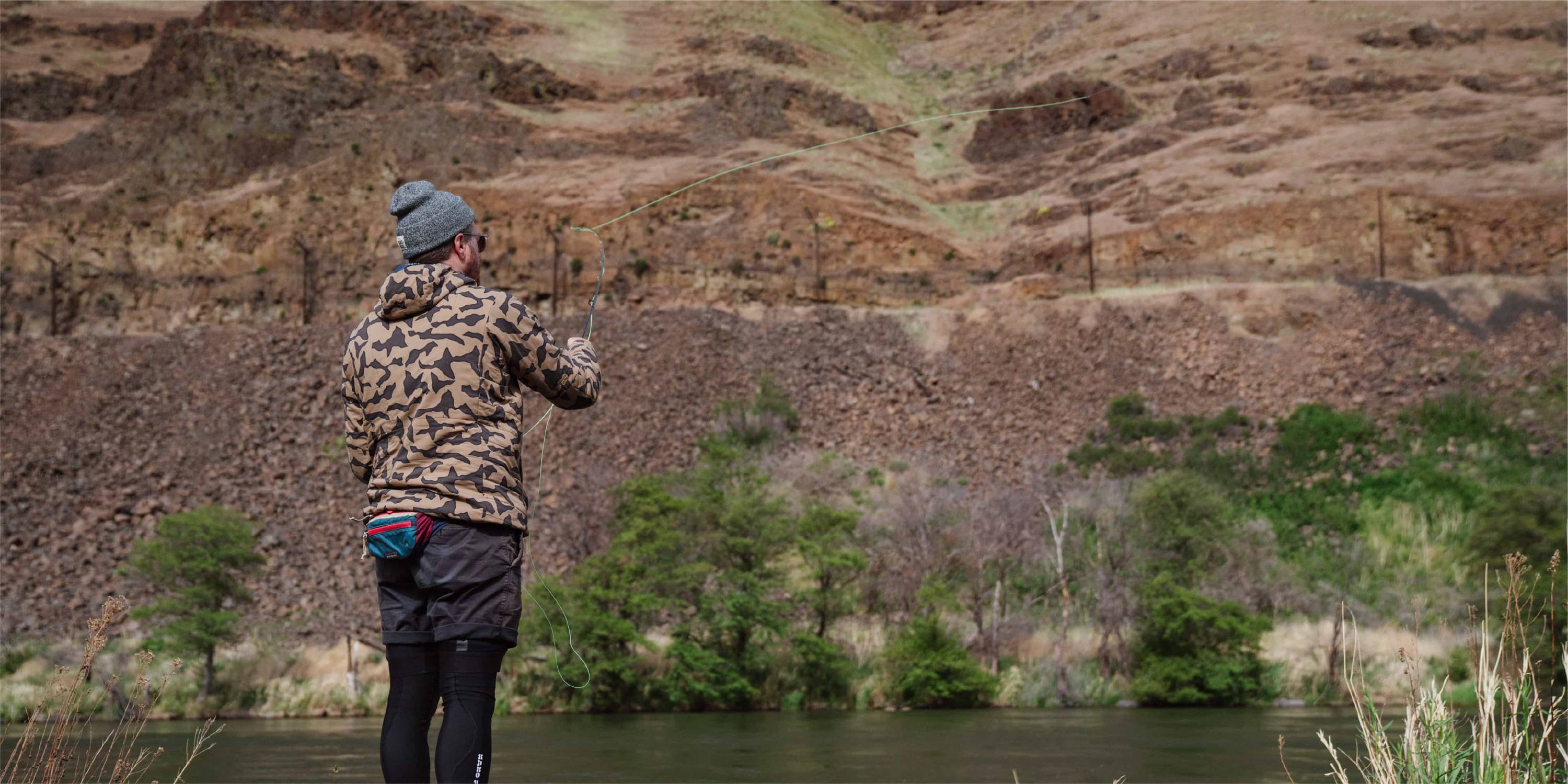 Brett Stenson fly fishing in canyon