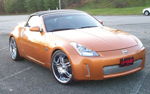 Front three-quarter copper Nissan 350Z Roadster chrome wheels black soft top UP-YOURS plate Nick's Conductor's Special 232 train horn kit featured customer install gallery photo 1
