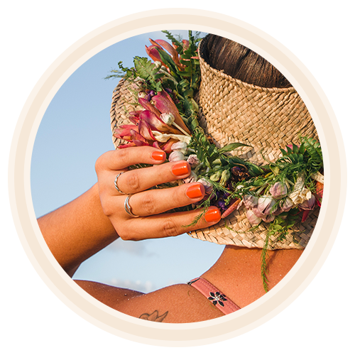 hawaiian women wearing olena non toxic nail polish touching her hat