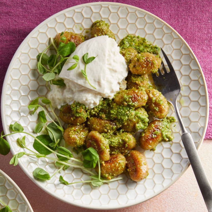 Pesto Gnocchi on A Plate With A Fork 