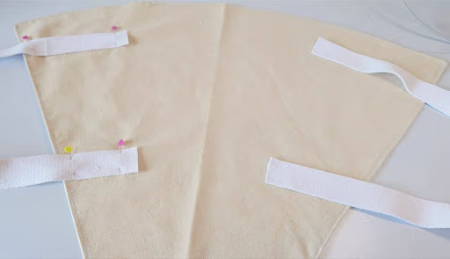 Two handles pinned at an angle on the fresh cut flower tote bag