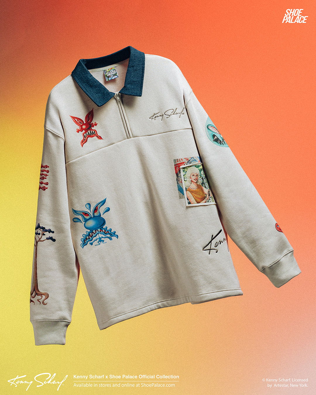 A beige collared sweatshirt with colorful embroidered designs against an orange background.