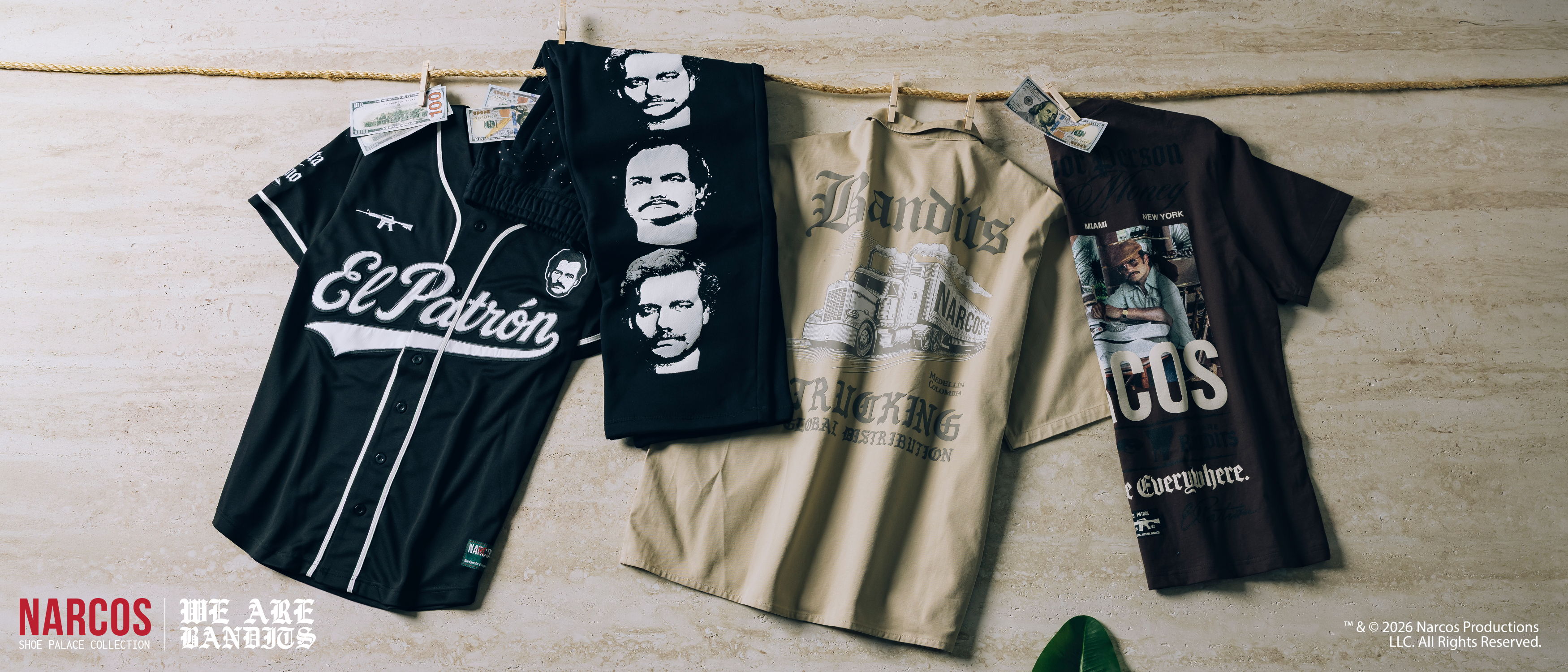 Four T-shirts displayed on a wooden surface.