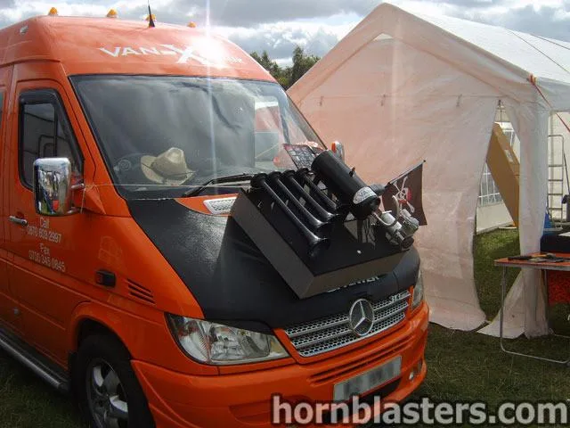 Side profile or street-level view of Reza's 2003 Mercedes-Benz Sprinter with Conductor's Special 232 train horn kit install context, HornBlasters gallery photo 2