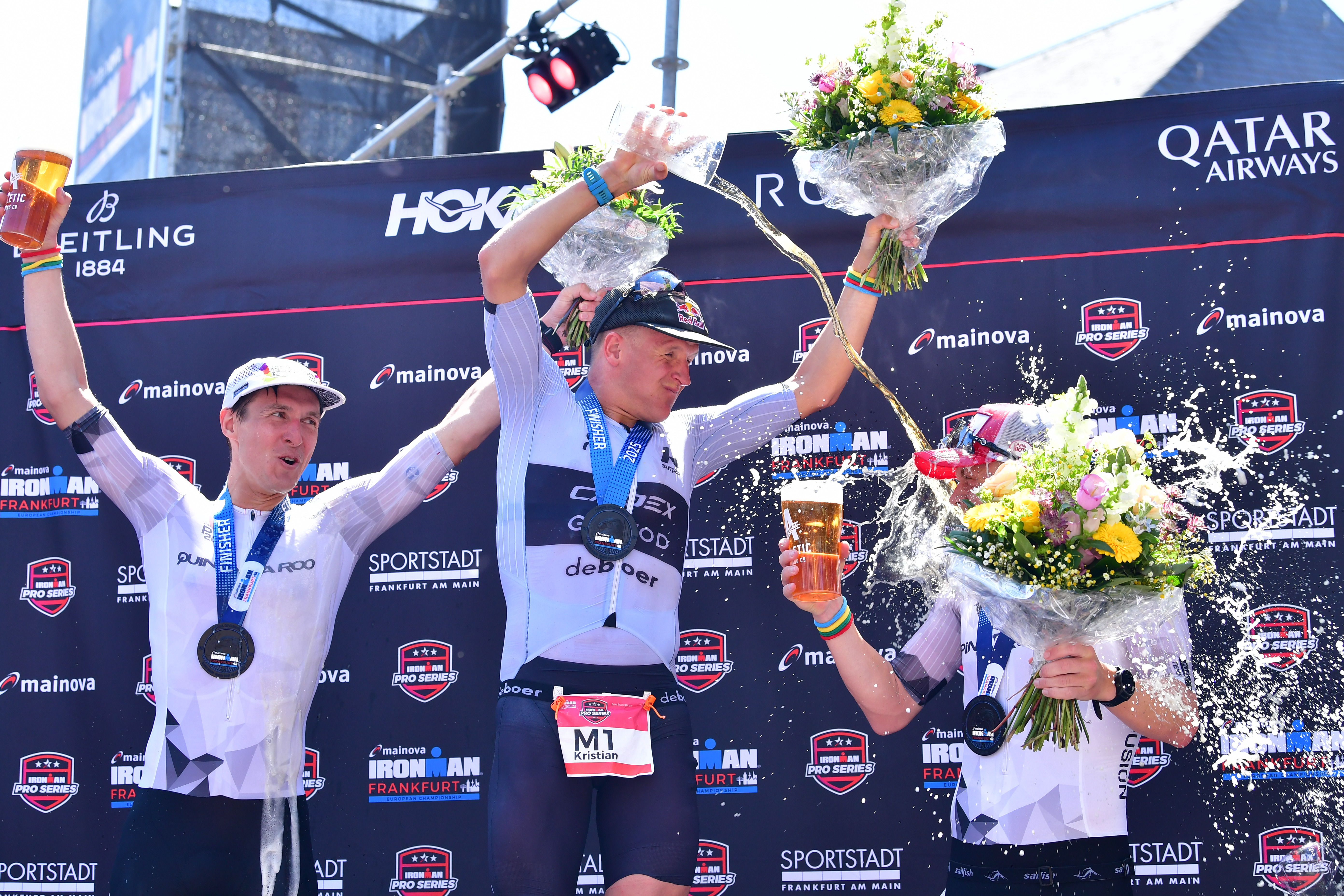Die drei Erstplatzierten der IRONMAN Frankfurt European Championship 2025: Kristian Høgenhaug (Dänemark, 2. Platz), Kristian Blummenfelt (Norwegen, 1. Platz) und Casper Nicolai Sagevik Stornes (Norwegen, 3. Platz) feiern am 29. Juni 2025 in Frankfurt am Main ihren Podestplatz.