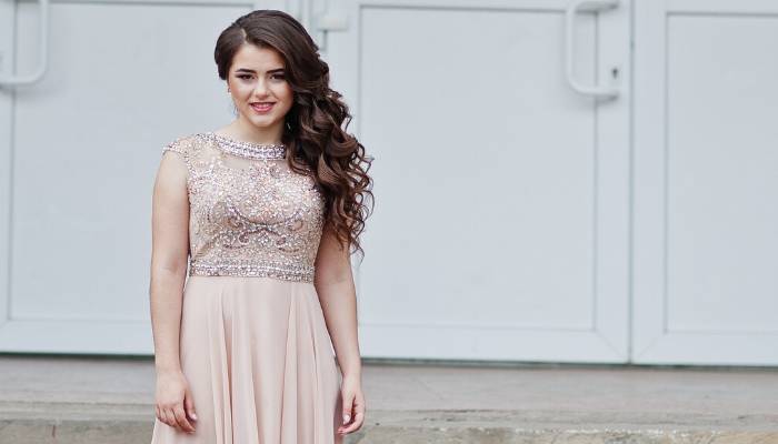 Teen girl wearing blush pink beaded prom dress