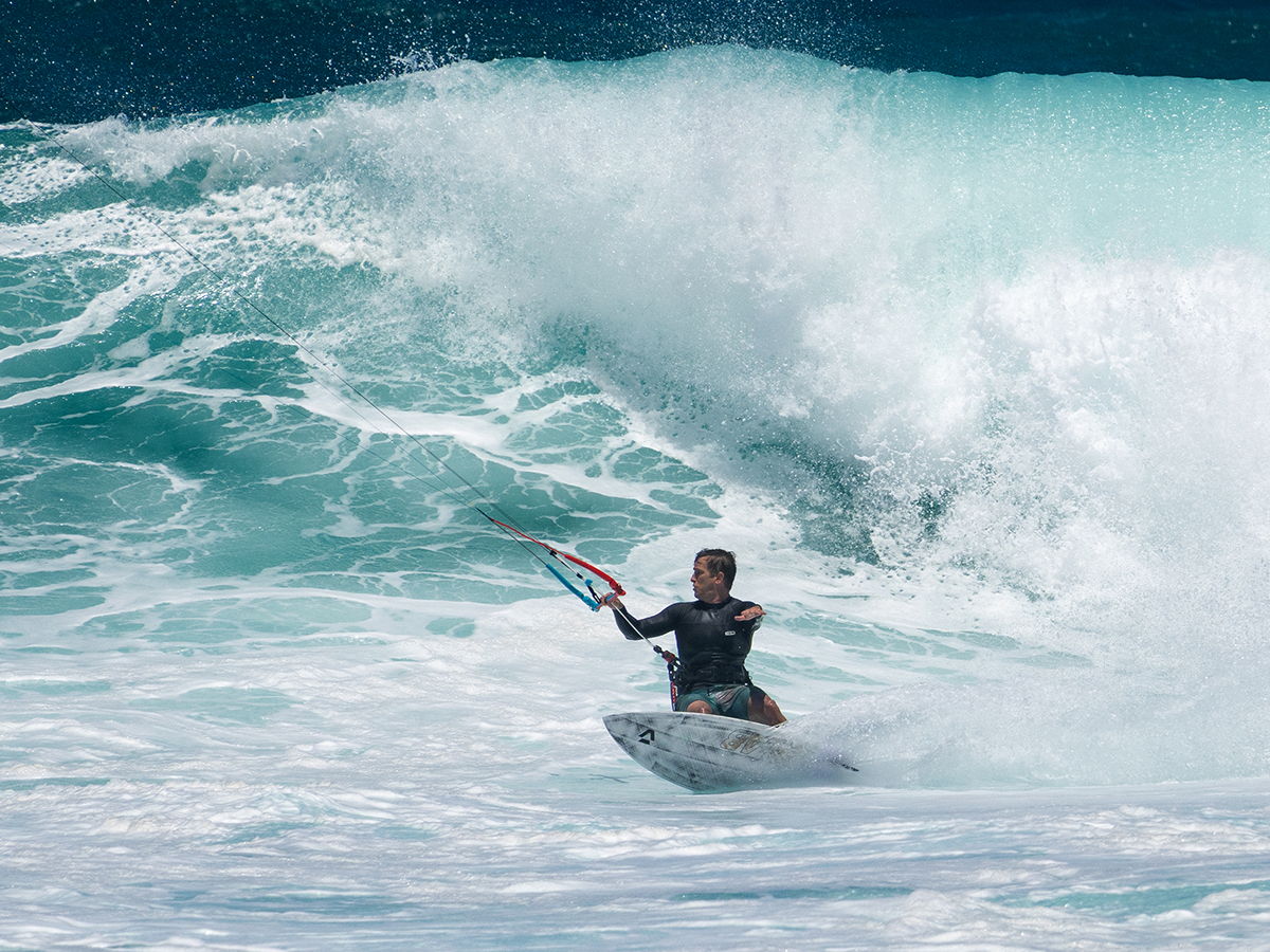 Surfer riding a wave in the ocean.