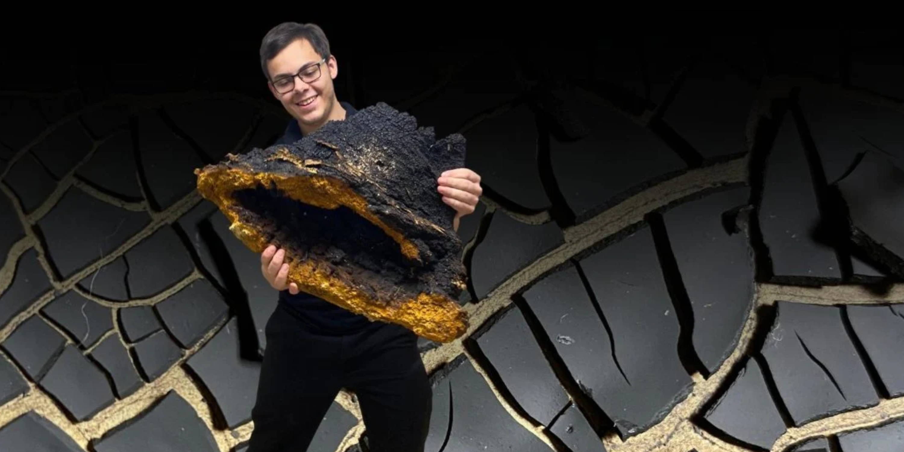 Birch Boys Company President holding a massive conk of chaga sclerotia, behind lies flakes of fungal melanin