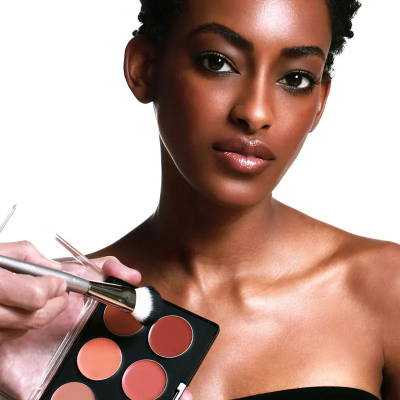 model with makeup palette and brush