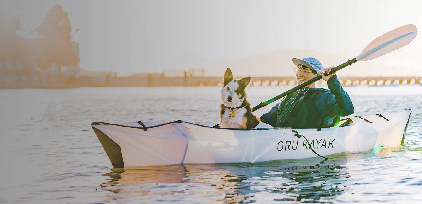 Paddler with Dog in an Oru Kayak Inlet