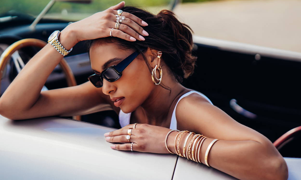 Model sitting in car wearing Ring Concierge fine jewelry