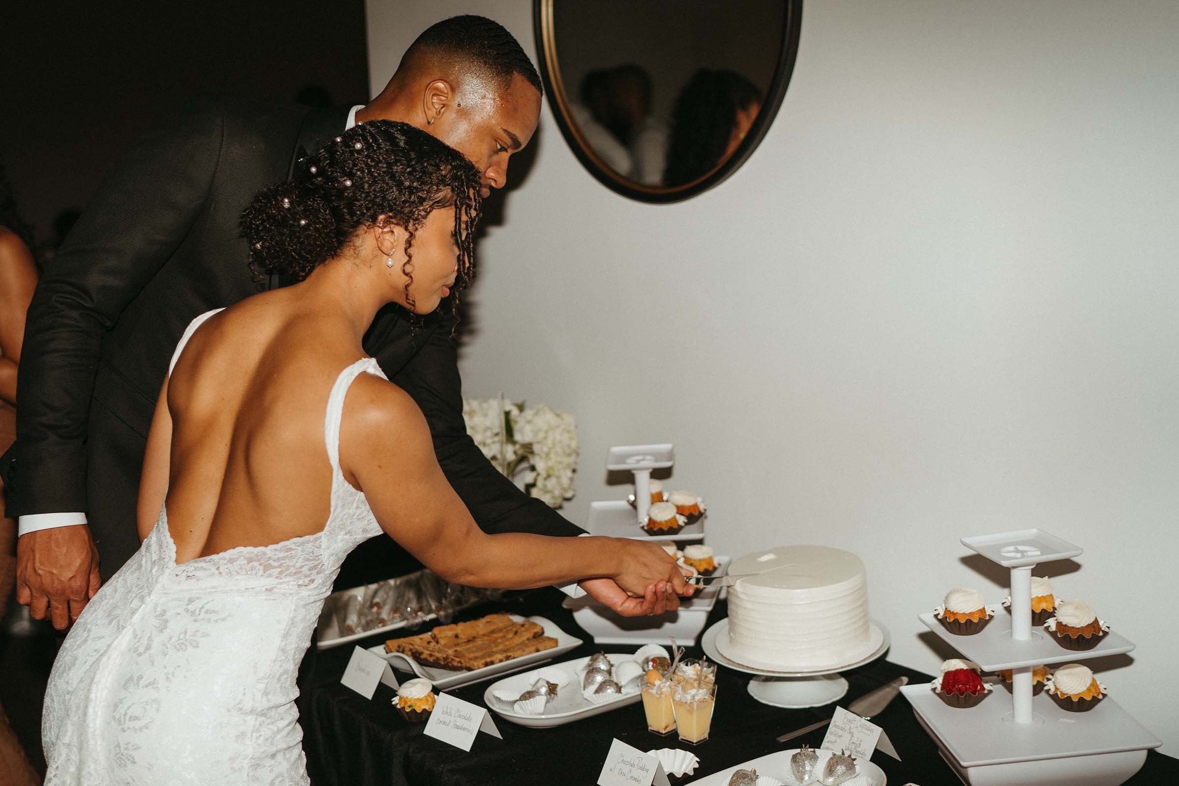 Bride and groom cutting cake