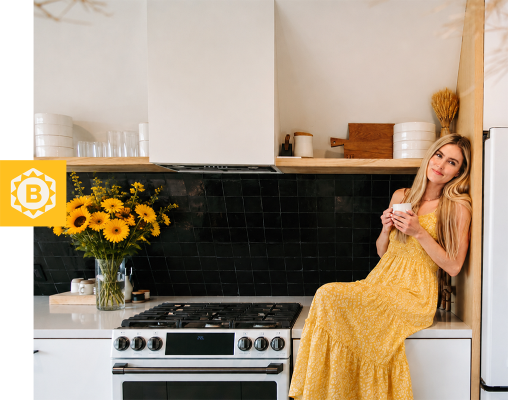 Woman in a yellow dress sitting on a kitchen counter with flowers.