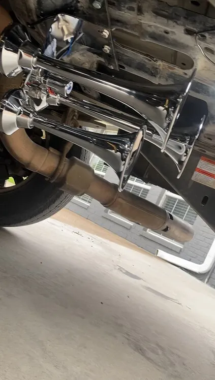 Dual chrome train horns mounted to the underside of Troy's Ford F250