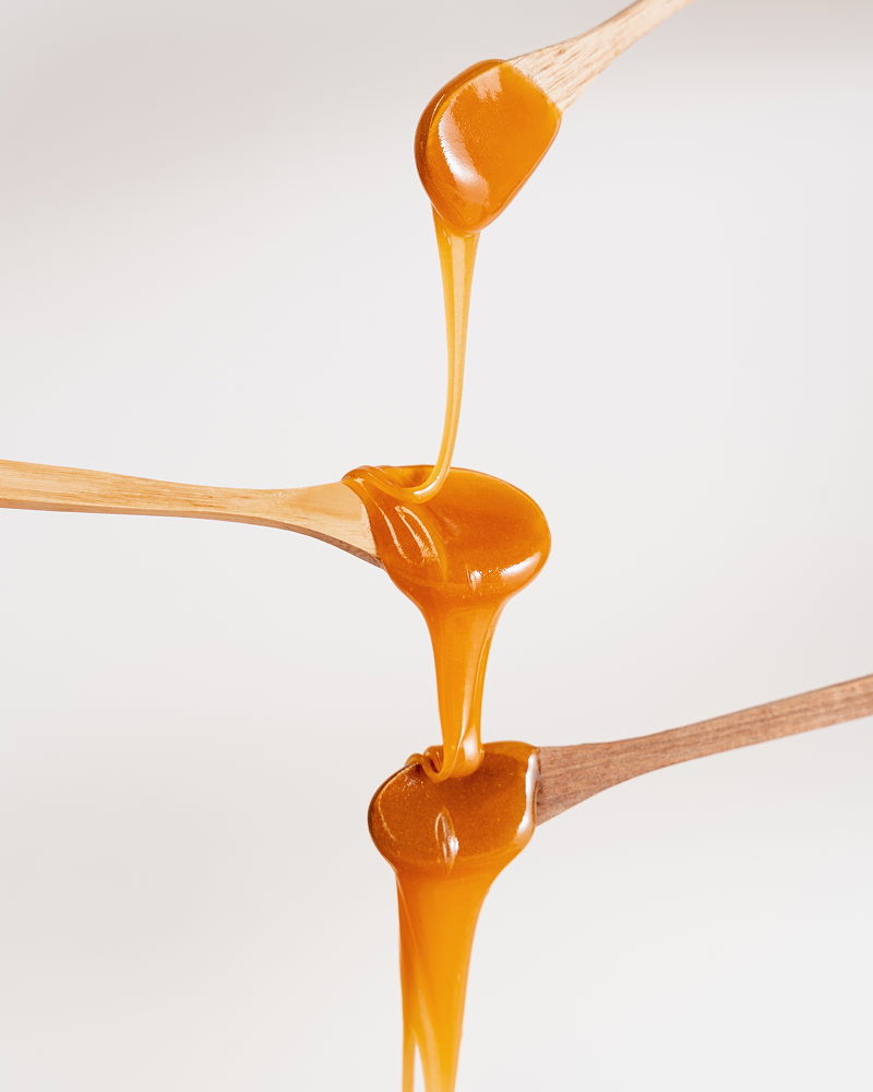 Honey Dripping On 3 Spoons