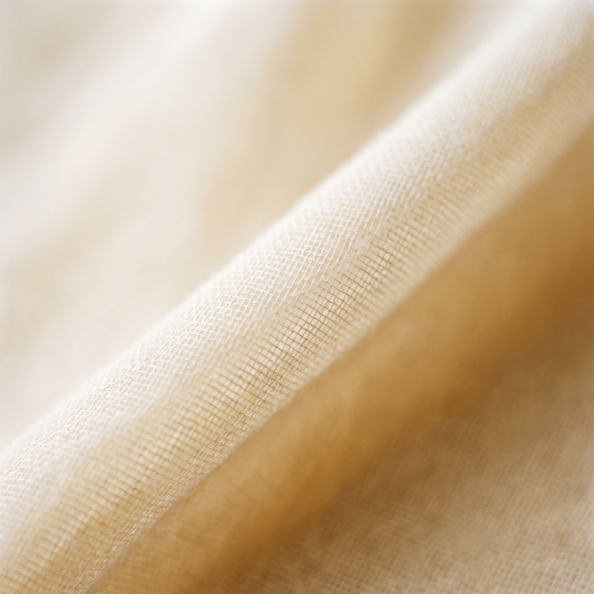 Close-up of soft, beige fabric with subtle texture.