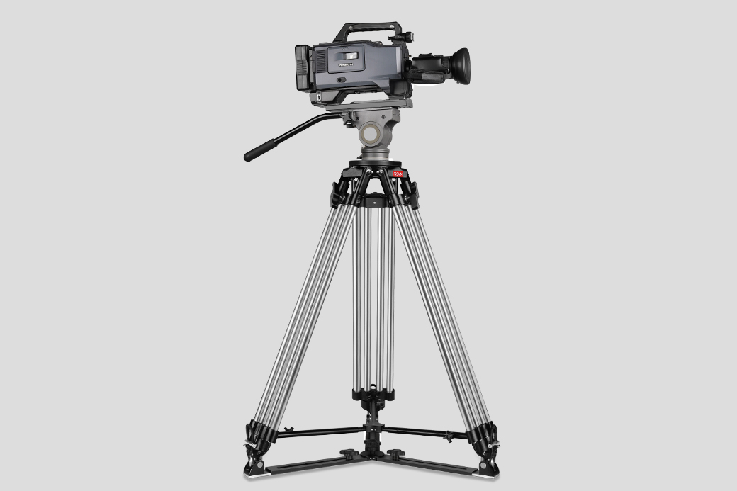 Camera mounted on a tripod against a gray background.