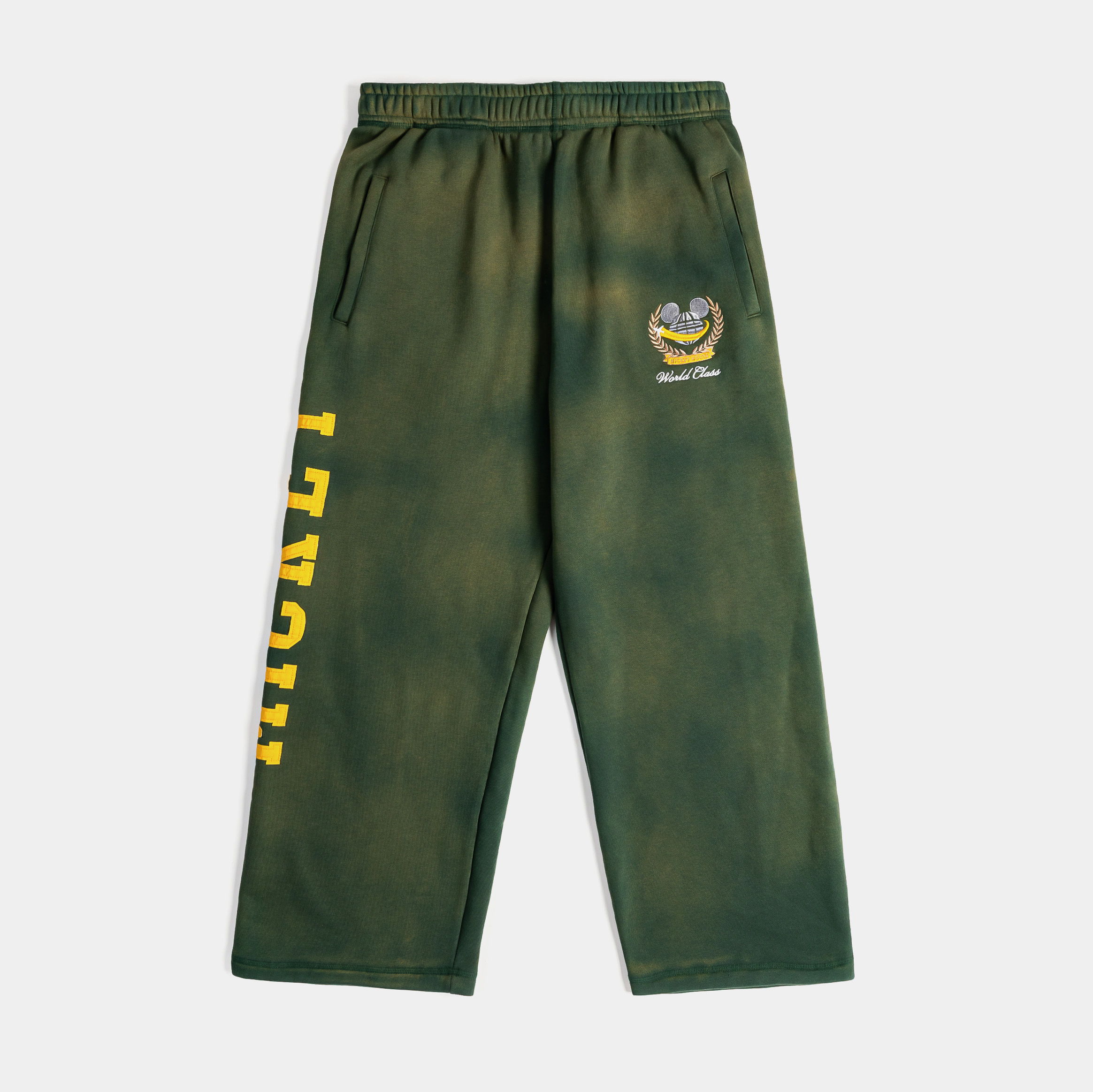Green tie-dye pants with yellow text and a smiley face logo.