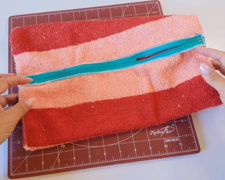 Side seams sewed of bag with zipper aligned in the middle