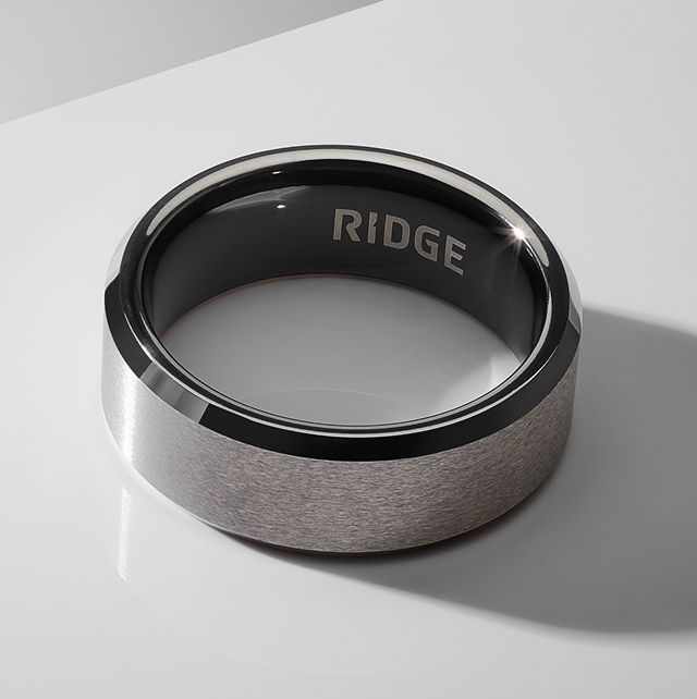 A sleek, modern ring with a black interior and silver exterior.