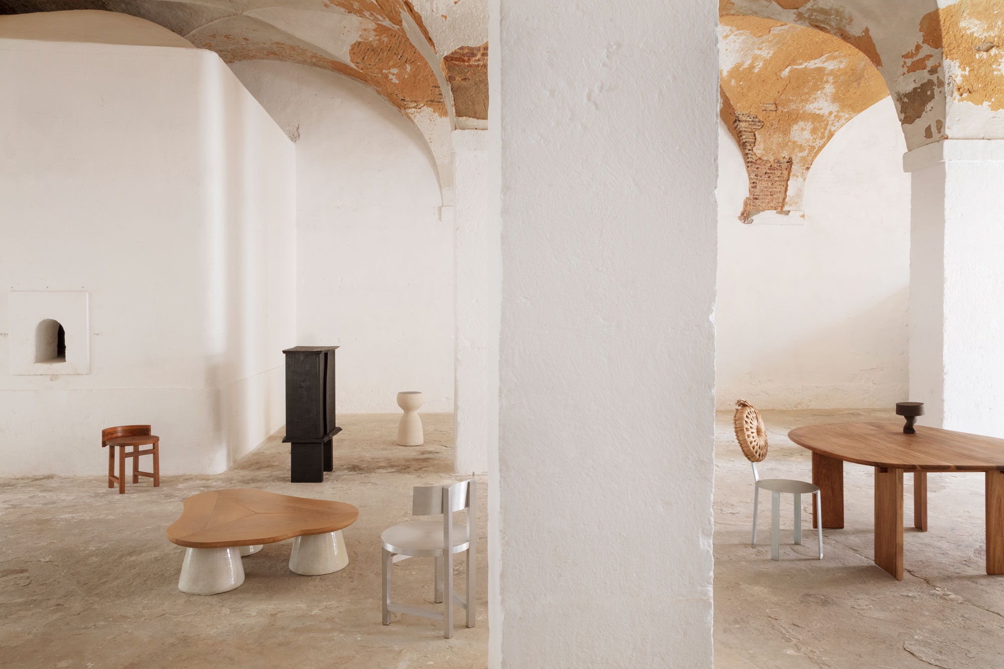 Modern interior with minimal furniture and arched ceilings.