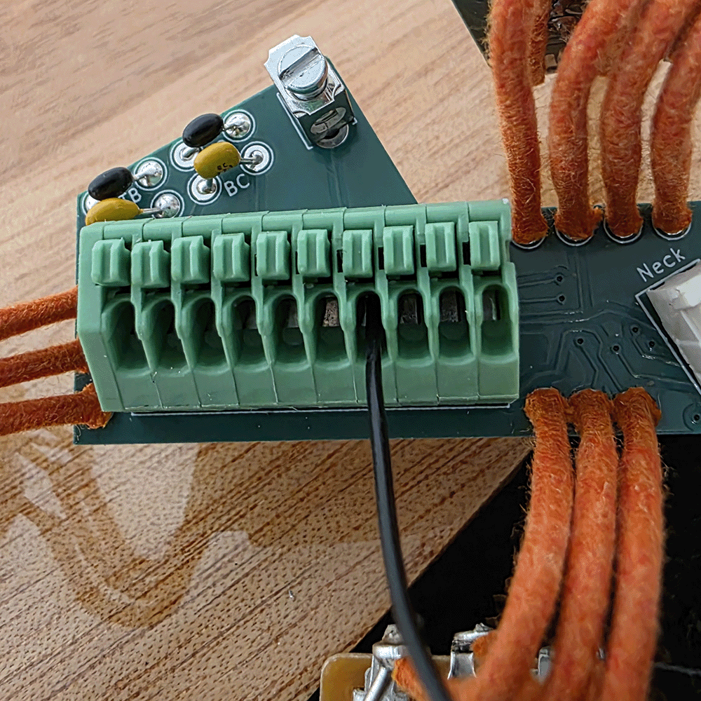 Close-up of a circuit board with connector and wires.