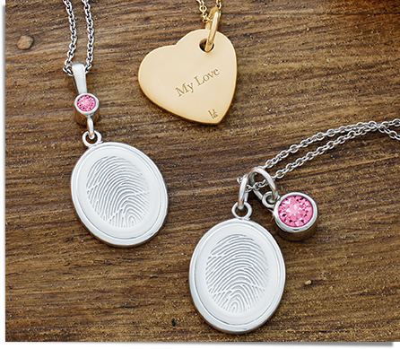 sterling silver oval fingerprint charms with swarovski crystal birthstone charms and yellow gold heart charm engraved with an inscription