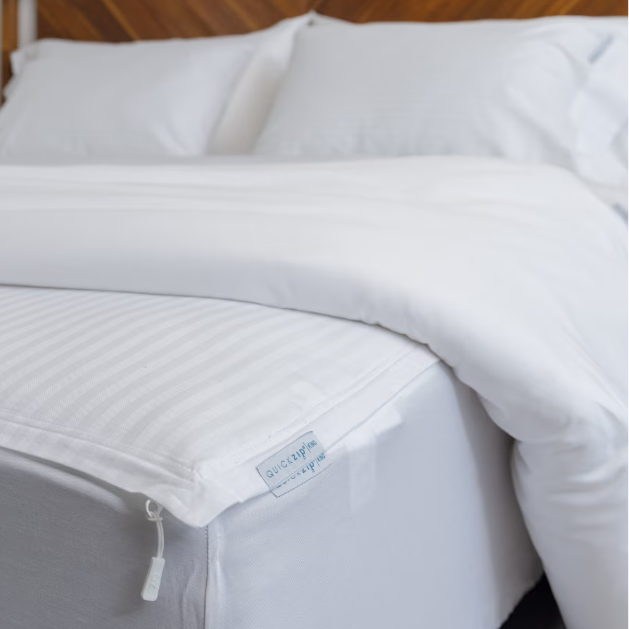 A bed made up with crisp white sheets