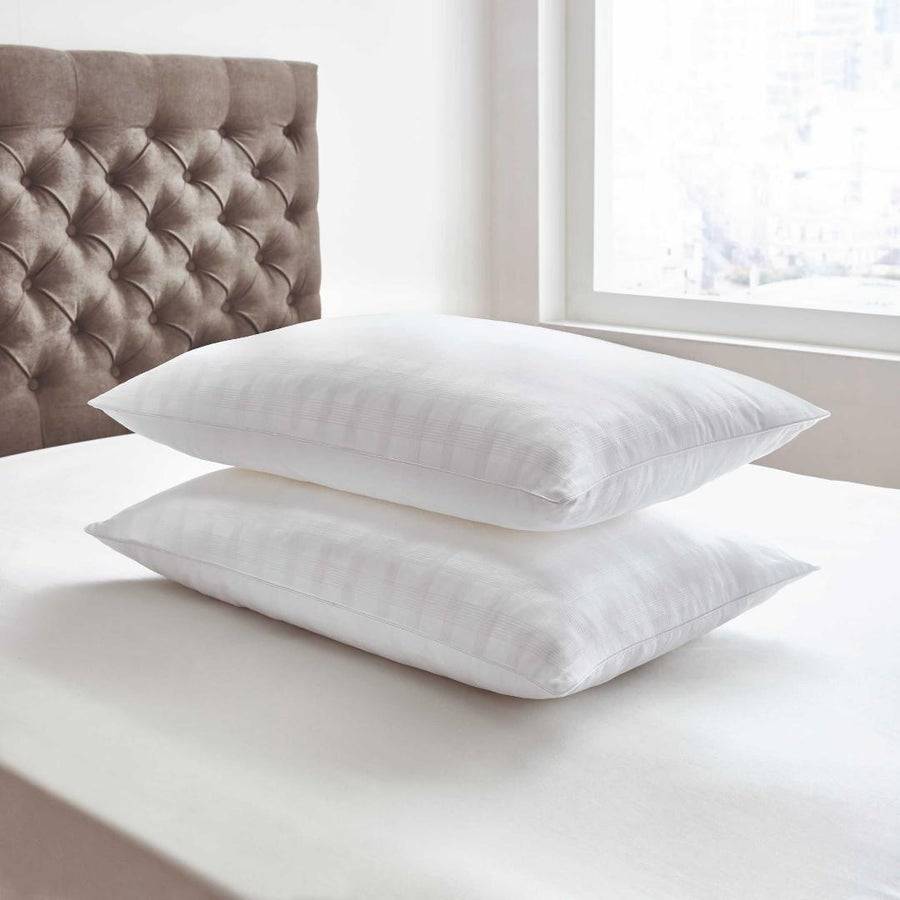 A pair of Bedeck Pillows on a bed