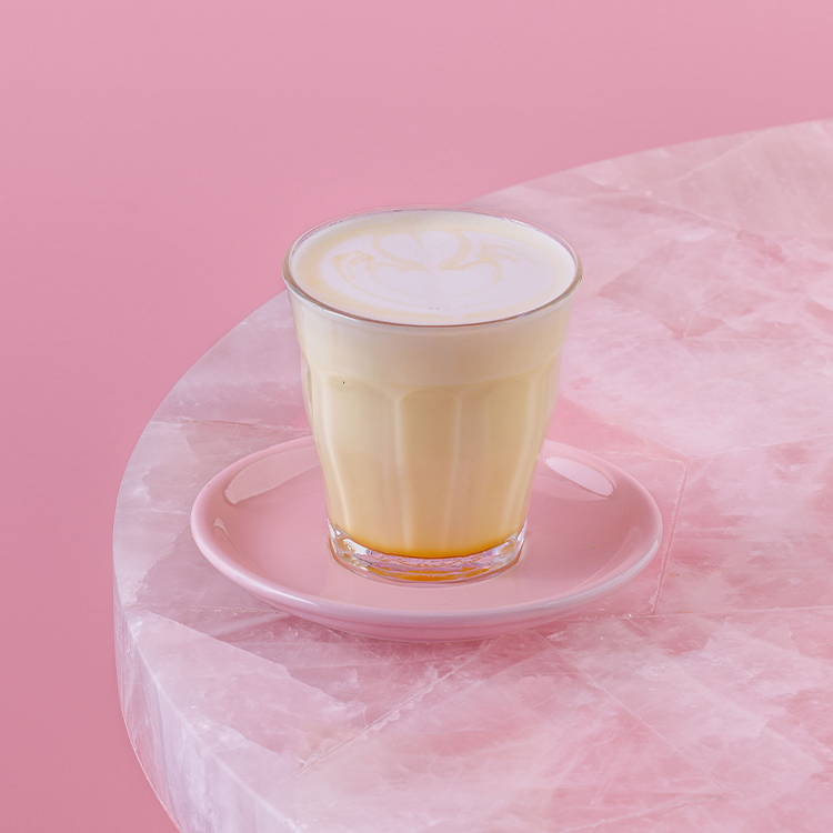 Saffron milk latte in pink background