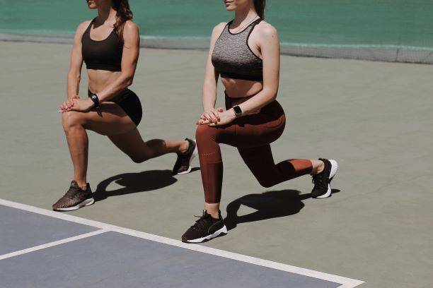 Two Women In Gym Clothes About To Run