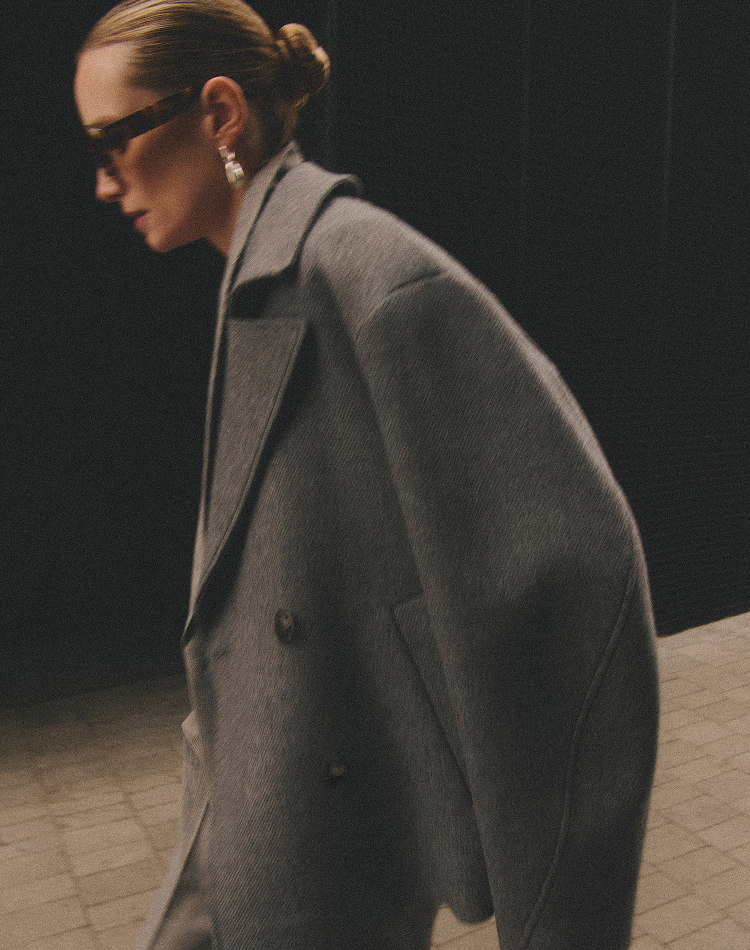 Model wearing grey Tero coat and sunglasses