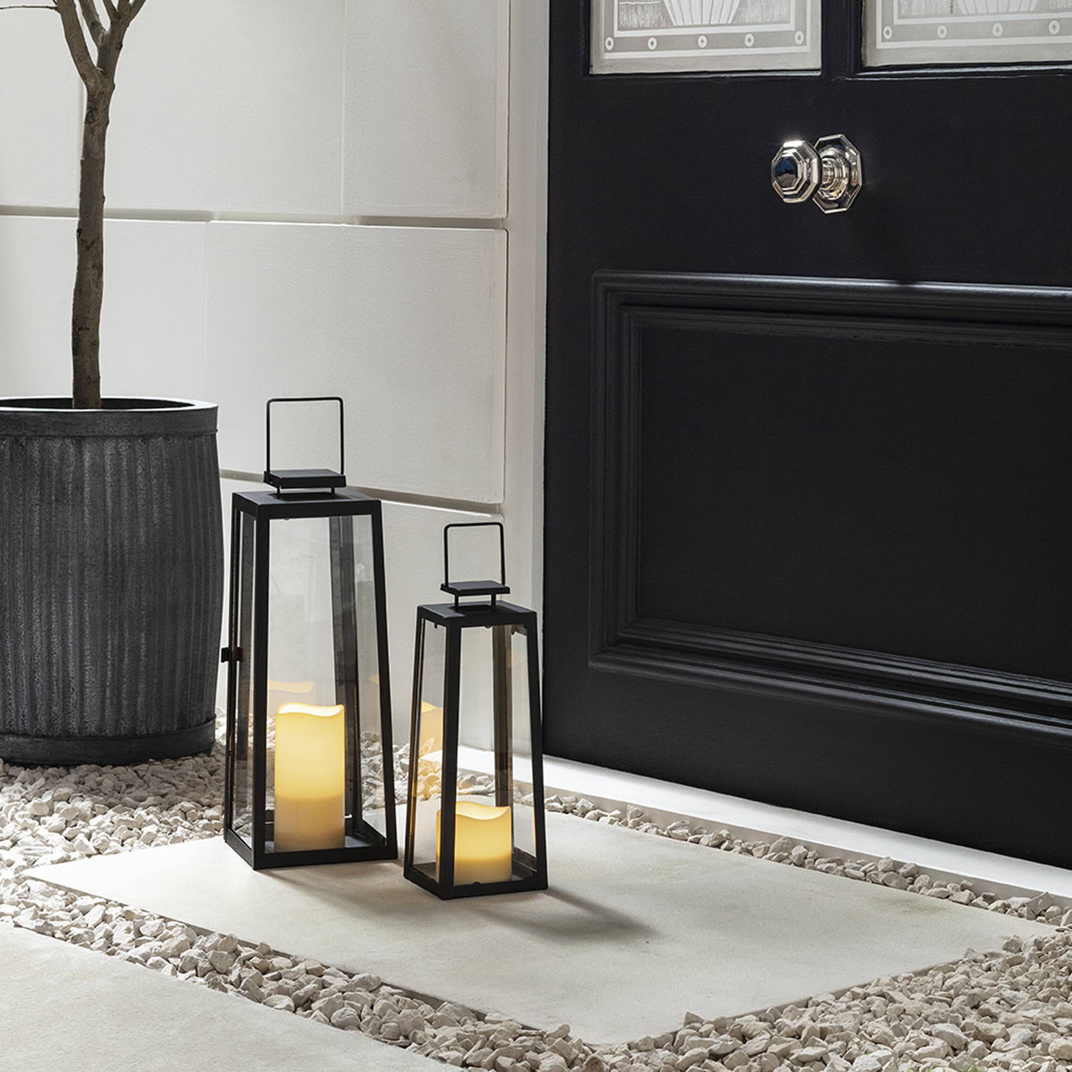 Front door setting featuring lanterns and LED candles