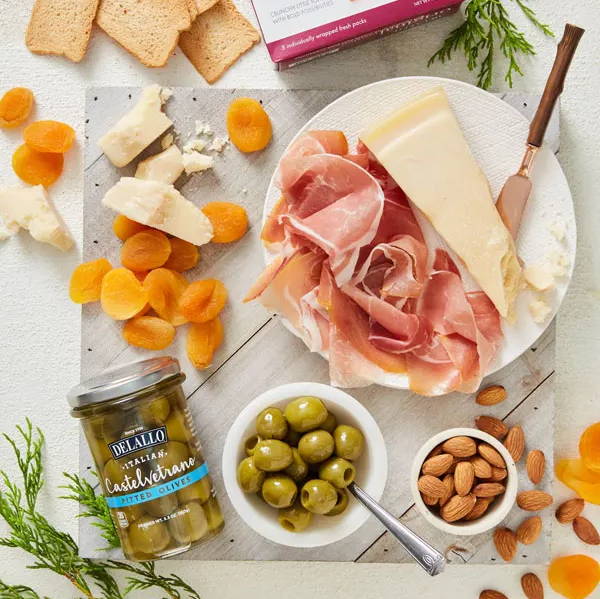 Link: image of jarred olives, meat, cheese, fruit and nuts