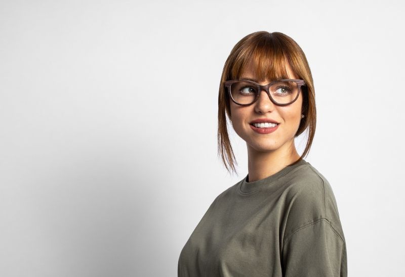 woman wearing Kraywoods square face shape glasses collection on a white background